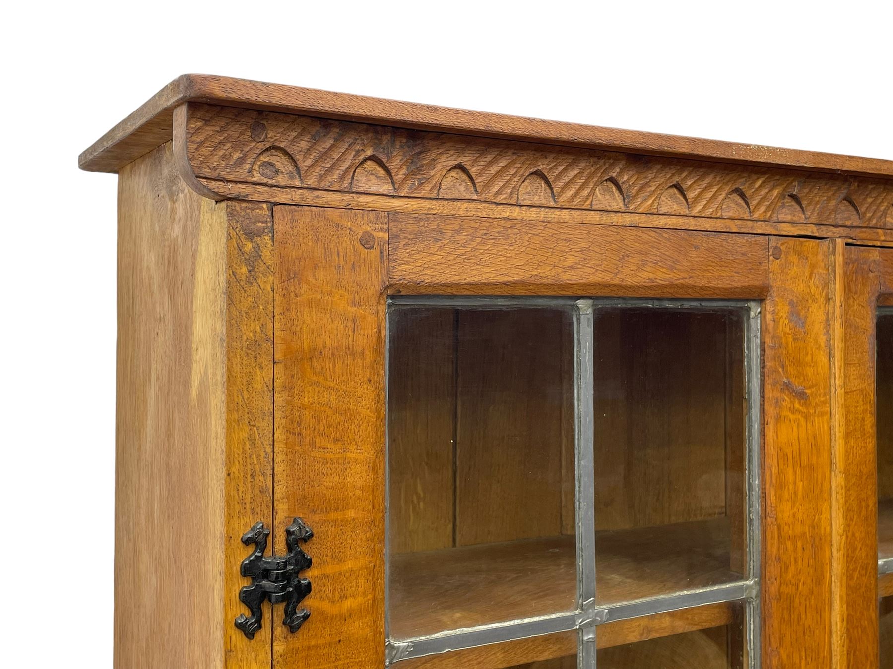 Gnomeman - adzed oak dresser, arcade carved cresting rail over two lead glazed doors, double cupboard below enclosed by two panelled doors, carved with gnome signature, by Thomas Whittaker, Little Beck 