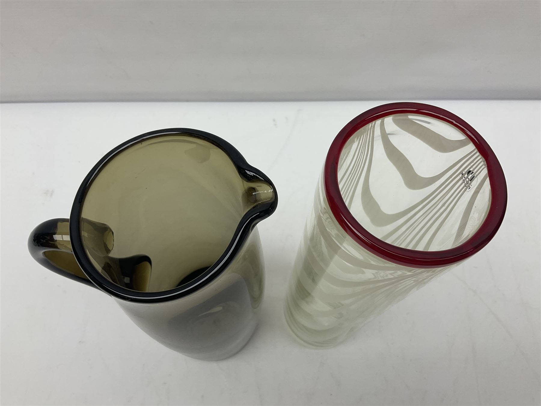 Two Whitefriars glass jugs, together with a Swedish Pukeberg art glass vase and three art glass bowls, including large pink example, some signed to base, tallest H30.5cm