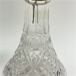 Silver plate mounted glass claret jug, the glass body of tapering form, the hinged lid a lion finial with shield shaped empty cartouche, the collar and spout cast with Bacchus face masks surrounded by grapes and vines, together with another silver plate mounted example, tallest H33cm