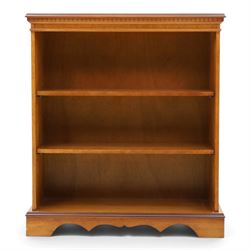 Contemporary mahogany and yew wood open bookcase, dentil cornice above two adjustable shel...