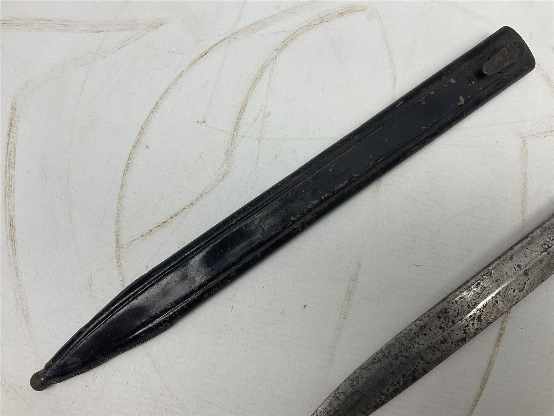 British No 7 MKI knife bayonet with 20cm single edged fullered clipped point blade;  blackened steel, large muzzle ring cross-guard; blackened swivelling pommel marked 'F5H'; red Tufnol composite grips; in blackened steel scabbard L33cm overall; British Pattern 1888 bayonet with scabbard; and German Ersatz bayonet with scabbard (3)