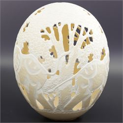 Ostrich egg with pierced decoration, depicting elephants in a forest, H16cm