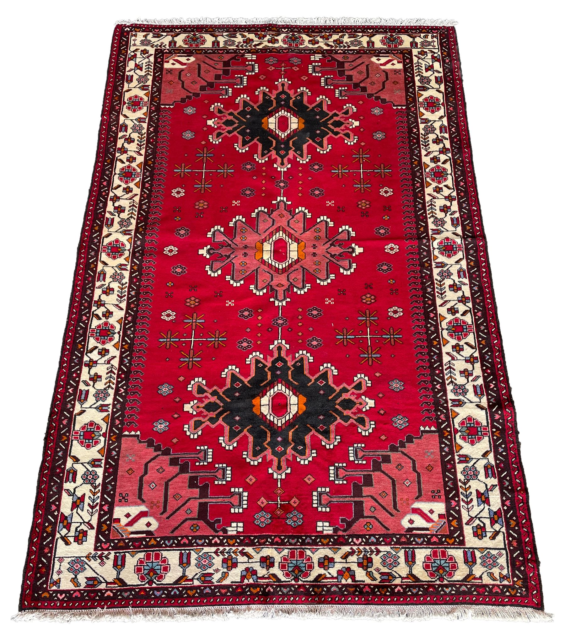Persian Hamandan rug, the red ground field decorated with triple medallions and stylised motifs
