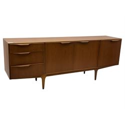 Tom Robertson for AH McIntosh & Co of Kirkaldy - mid-20th century teak 'Dunvegan' sideboard, with three graduating drawers fitted cutlery divider, three cupboards one fall front each with recessed sculptural handles, raised on shaped and tapering supports