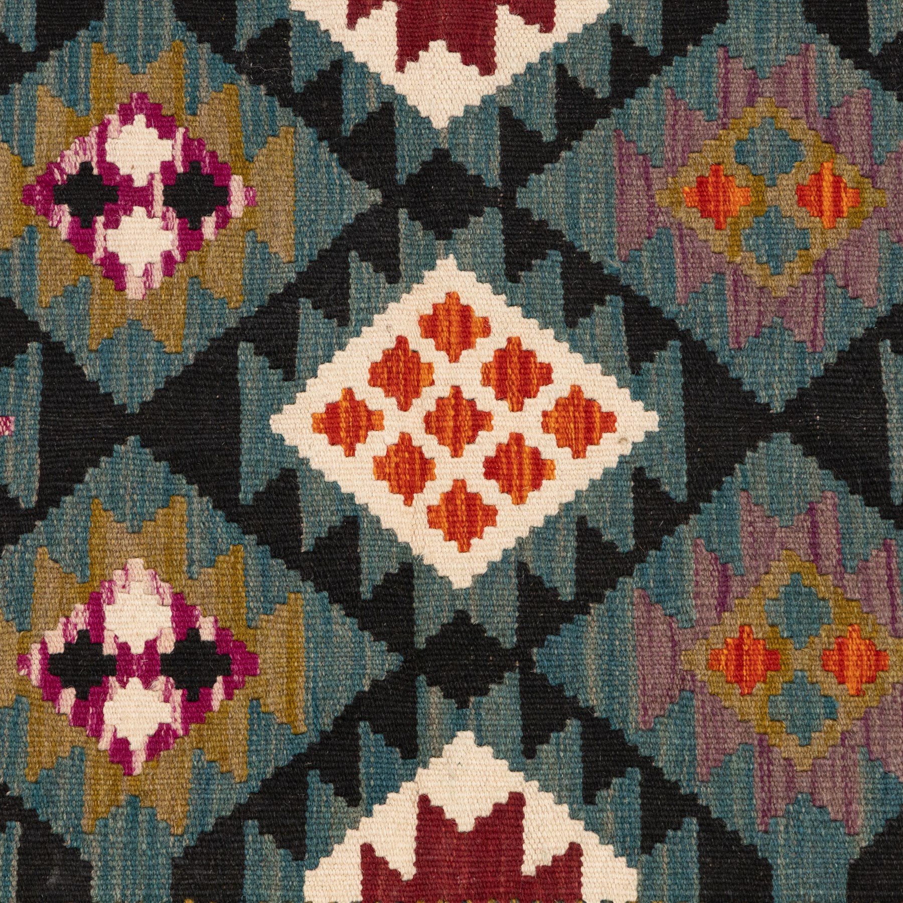 Afghan kilim teal ground runner rug, the field decorated with assorted lozenges with geometric motifs and dark indigo borders, enclosed by a narrow striped guard band