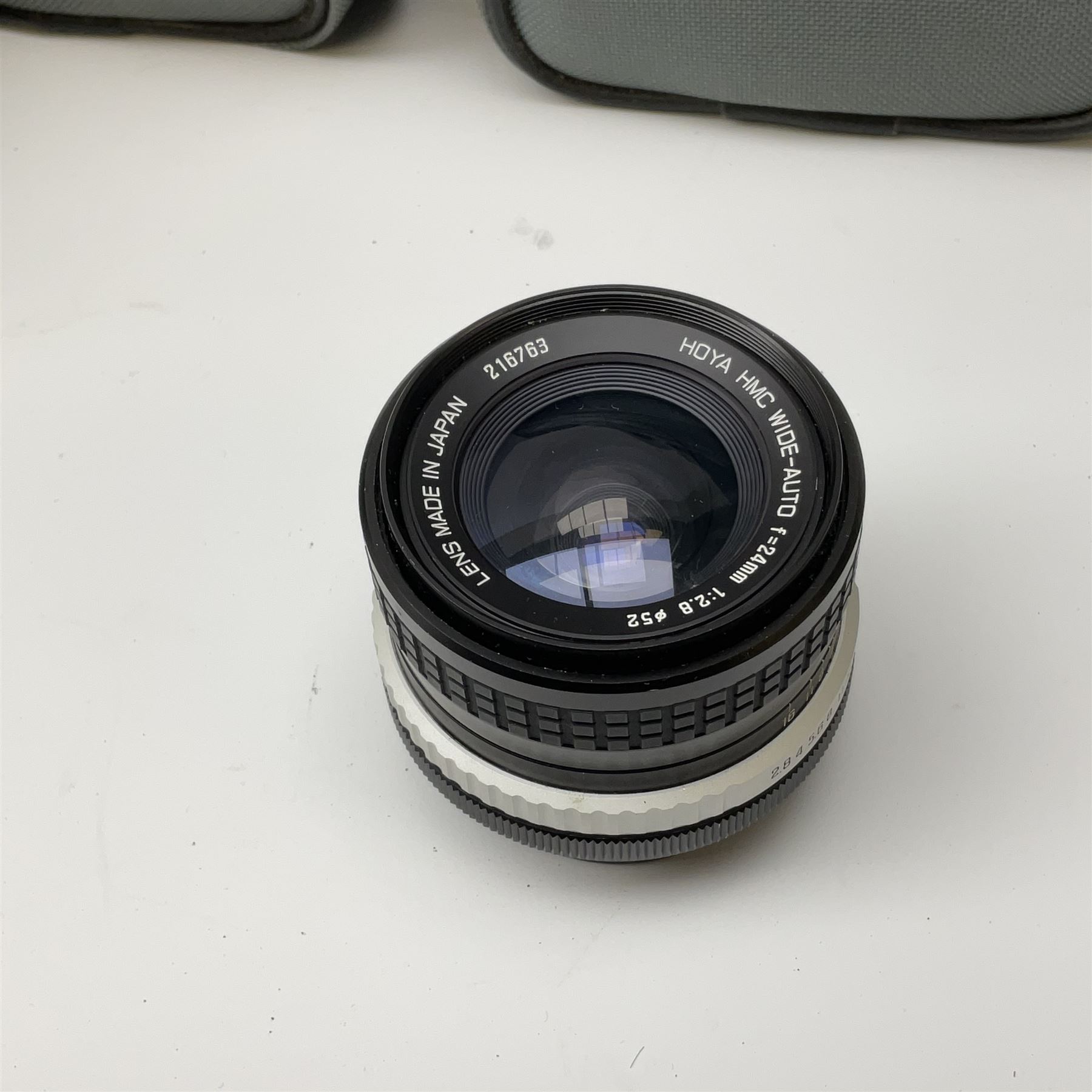 Canon AE1 camera, 'no. 4403757', fitted with Canon 'FD 50mm 1:1.8' lens, Hoya 'HMC Wide-Auto f24mm 1:2.8' lens and various other lenses and camera accessories, housed in a soft carry bag