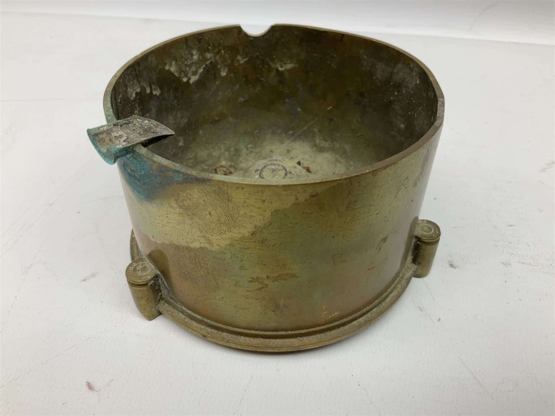 Trench Art - three WW2 brass shell case ashtrays, one mounted with Royal Artillery cap badge and button and one mounted with RA button; together with a pair of place name holders each formed from a Royal Artillery cap badge (5)