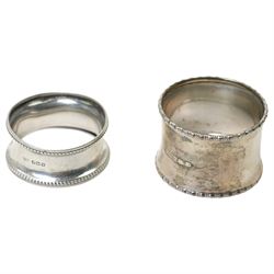 Two silver napkin rings, silver mirror frame and various silver spoons