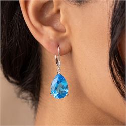 Pair of 18ct white gold Swiss blue topaz and diamond earrings, each pendant set with a single pear cut topaz suspedning from a two stone diaond set bail, stamped 750