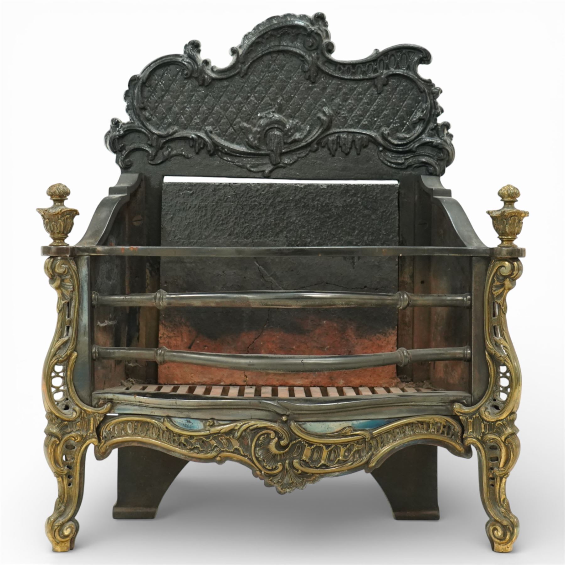 20th century Rococo style fire basket, cast iron back plate with pierced and scroll moulded cresting, steel fire bars and grate, ormolu mounted uprights with foliate scrollwork, on shaped feet