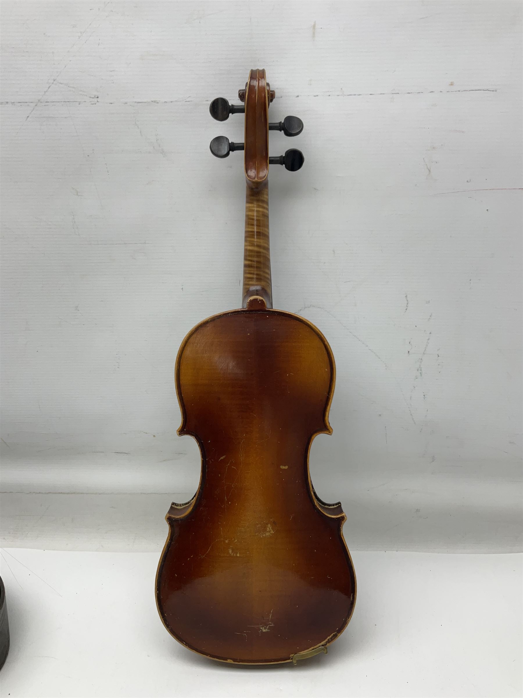 Czechoslovakian violin c1920 with 36cm two-piece maple back and ribs and spruce top, bears label 'Copy of Antonius Stradivarius Made in Czechoslovakia' L59cm; in carrying case; 1950s Czechoslovakian violin; and 195os Czechoslovakian three-quarter size violin; both cased (3)