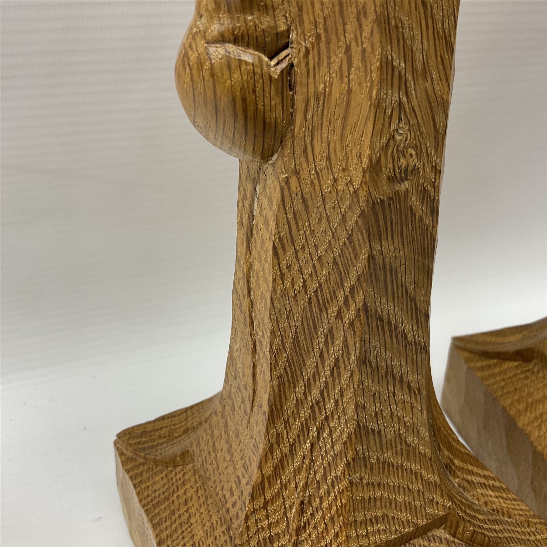 Mouseman - pair of tooled oak candlesticks, wrought iron sconce with drip tray over tapered octagonal column carved with mouse signature, terminating to stylised leaf carved square base, by the workshop of Robert Thompson, Kilburn
