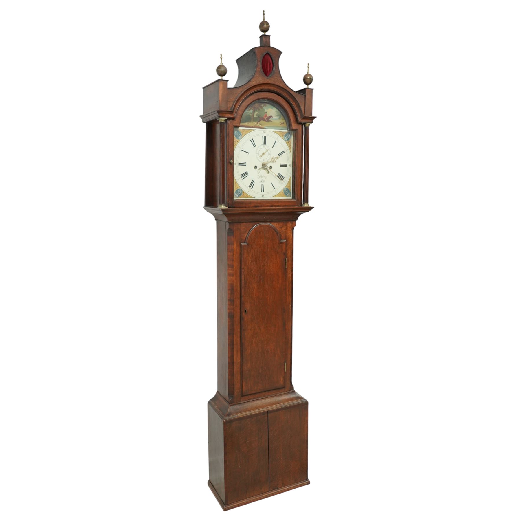 Patrick Forrester of Hull-early 19th century 8-day oak and mahogany longcase, c1830, With a pagoda pediment and three matching ball and spire finials, break arch hood door beneath flanked by reeded pilasters with brass capitals, trunk with canted corners and a full length break arch topped door with crossbanding, on a square plinth with an applied moulding to the base, fully painted dial with matching spandrels and a scene of a huntsman to the arch, with Roman numerals, fifteen minute Arabic's, stamped brass hands, seconds dial and date aperture, dial pinned via a falseplate to a rack striking movement, striking the hours on a bell. With key, weights and pendulum.   A good example of this refined design of case popular in the East Riding of Yorkshire and London, the hood is of particularly good proportions.
Patrick Forrester is listed as working in Hull 1813-1840, also as a Jeweller and Goldsmith.         