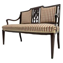 Edwardian mahogany framed three-piece salon suite - two-seat sofa, stepped cresting rail over acanthus and scroll carved pierced splat, upholstered in striped fabric (W124cm, H87cm, D62cm); and a pair of matching armchairs (W60cm) 