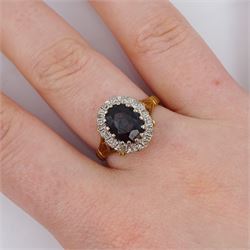 18ct gold oval cut garnet and round brilliant cut diamond cluster ring, London 1975