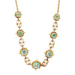 19th century gold emerald necklace, seven closed back octagonal cut and square cut emeralds, surrounded by a fancy bead setting, each spaced by a pierced scroll and bead design link, to a cable link chain necklace, with The Gem & Pearl Laboratory report