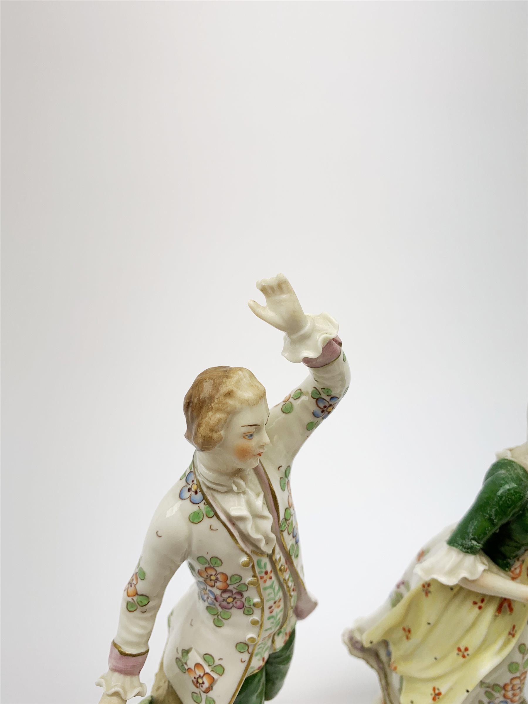 A pair of Sitzendorf figures, modelled as a male and female figure in eighteenth century dress with sheep beside feet, each upon gilt detailed circular base, each with printed mark beneath, tallest H18.5cm, together with a Volkstedt figure modelled as a Eastern female figure with camel seated at her feet, with printed mark beneath, a Sitzendorf figure of a young male figure, a figure modelled as a seated female playing the lute, with dog seated upon her lap, and a figure group marked foreign. (6). 