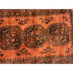 Near pair Afghan Bokhara wool pile rugs, the field decorated with four central Gul motifs, surrounded by multi-band border with repeating lozenges (2)