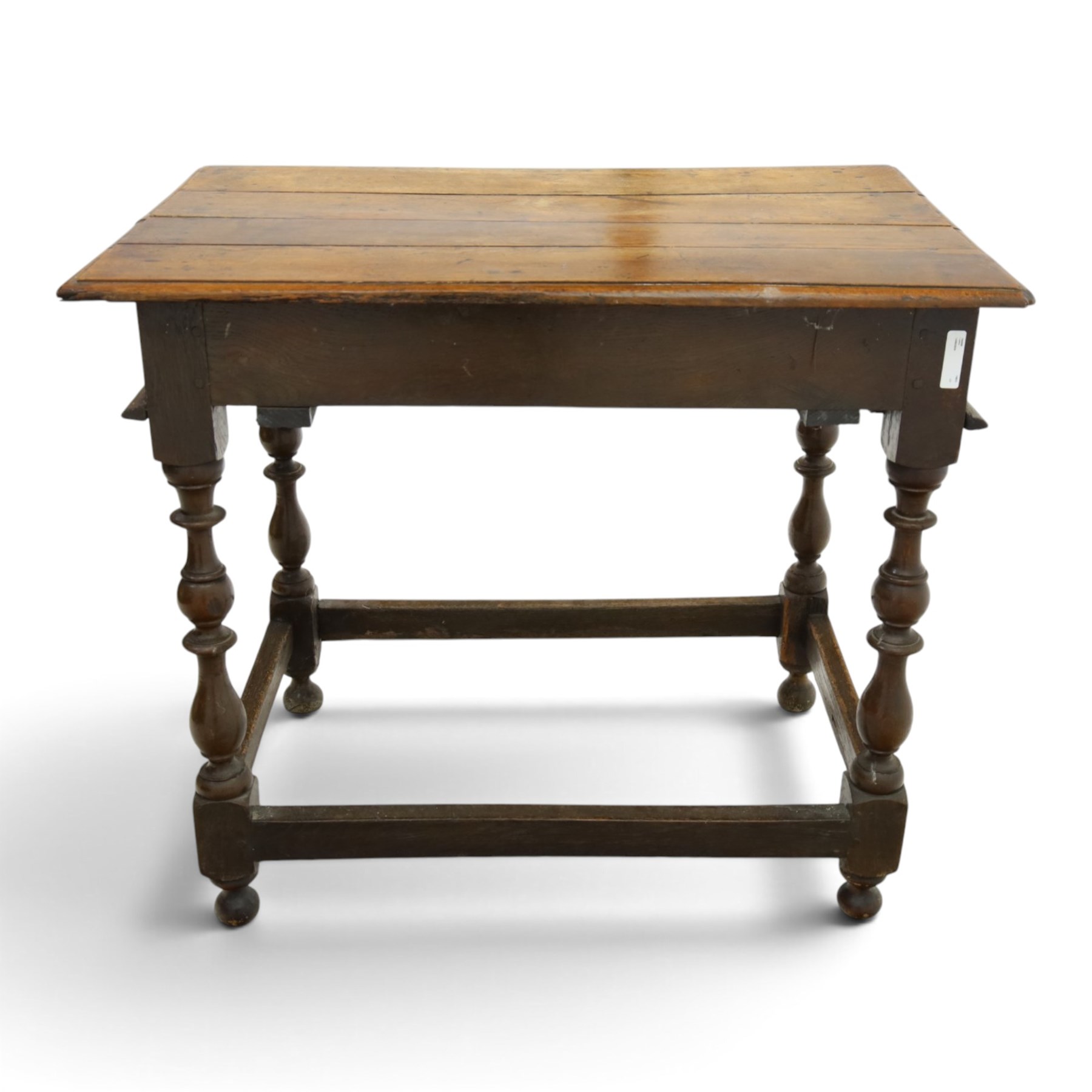 18th century oak lowboy, rectangular top with moulded edge, fitted with single frieze drawer carved with scrolling fruiting vines and stylised plant motifs, raised on bobbin-turned supports united by box stretcher 