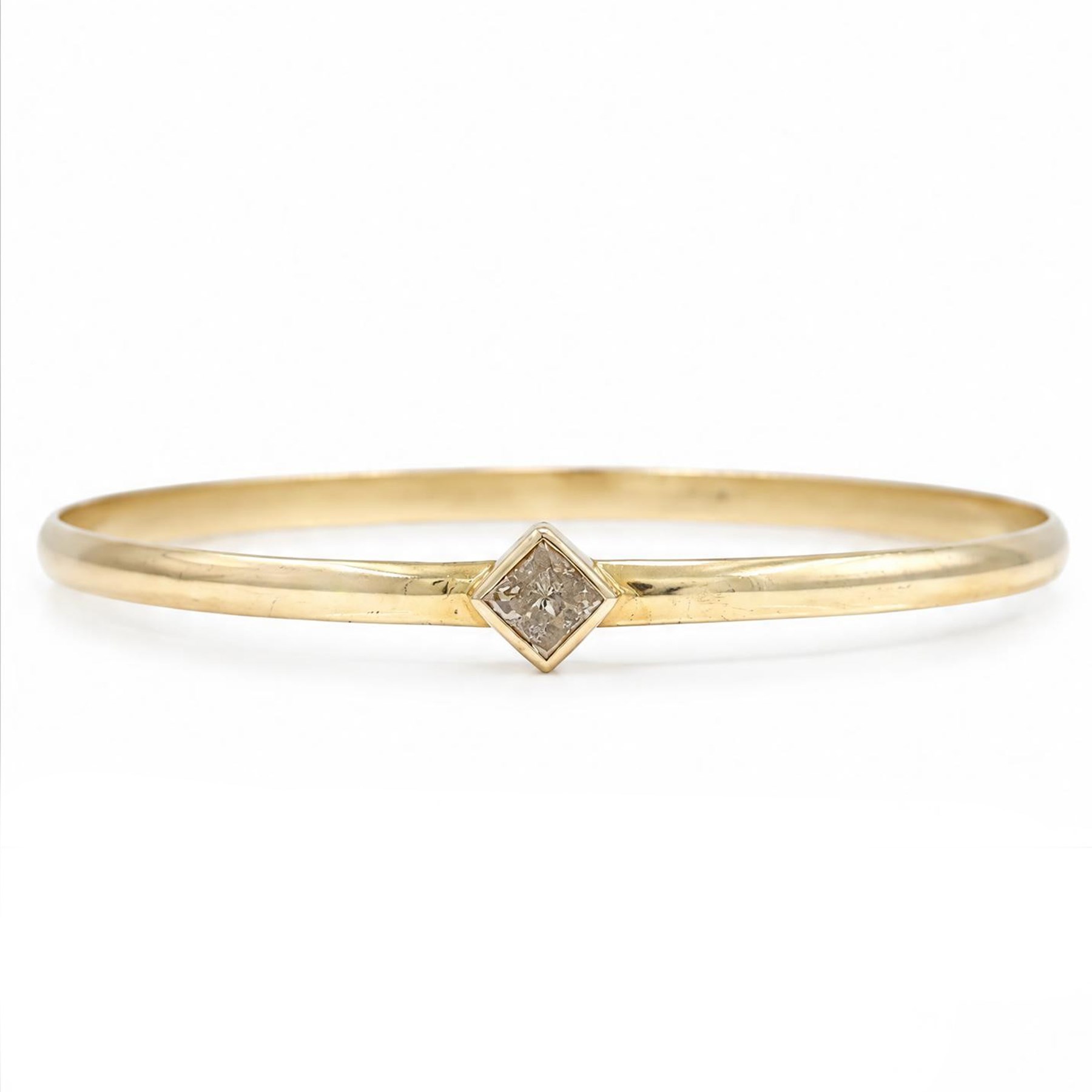 18ct gold fancy champagne / brown diamond bangle, bezel set with a single princess cut diamond of approx 0.70 carat, stamped 750
