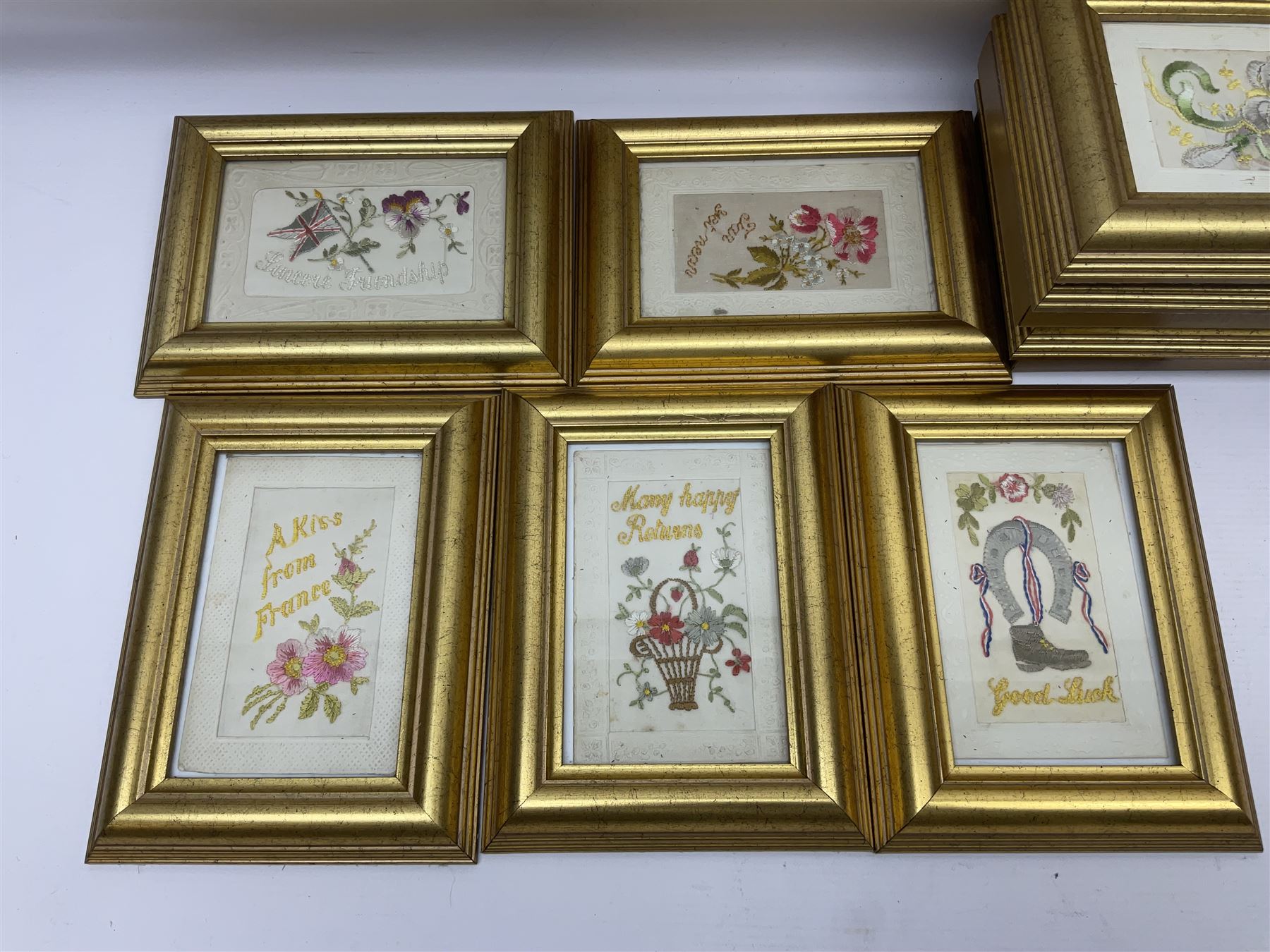 Collection of twenty eight, mostly WWI period embroidered silk greetings cards and postcards, including 'A kiss from France', good luck, sweetheart and Christmas examples, all within modern gilt frames