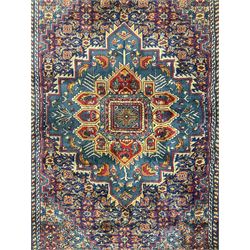 Persian design blue ground rug, the field decorated with Herati motifs and central floral medallion, repeating guarded border decorate with flower heads and trailing leafy branches 