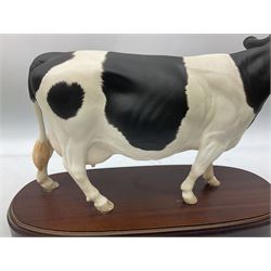 Beswick Connoisseur model of a Charolais Bull, on wood plinth, together with Royal Doulton matt Friesian cow, on wooden plinth, both with printed mark beneath 