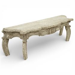 French style low console table, the shaped rectangular top with undulating outline and moulded edge, worn painted finish throughout, the frieze carved with flowing C-scrolls, shell and foliate detail centred by a floral reserve, on cabriole legs with carved knees and inward curving feet