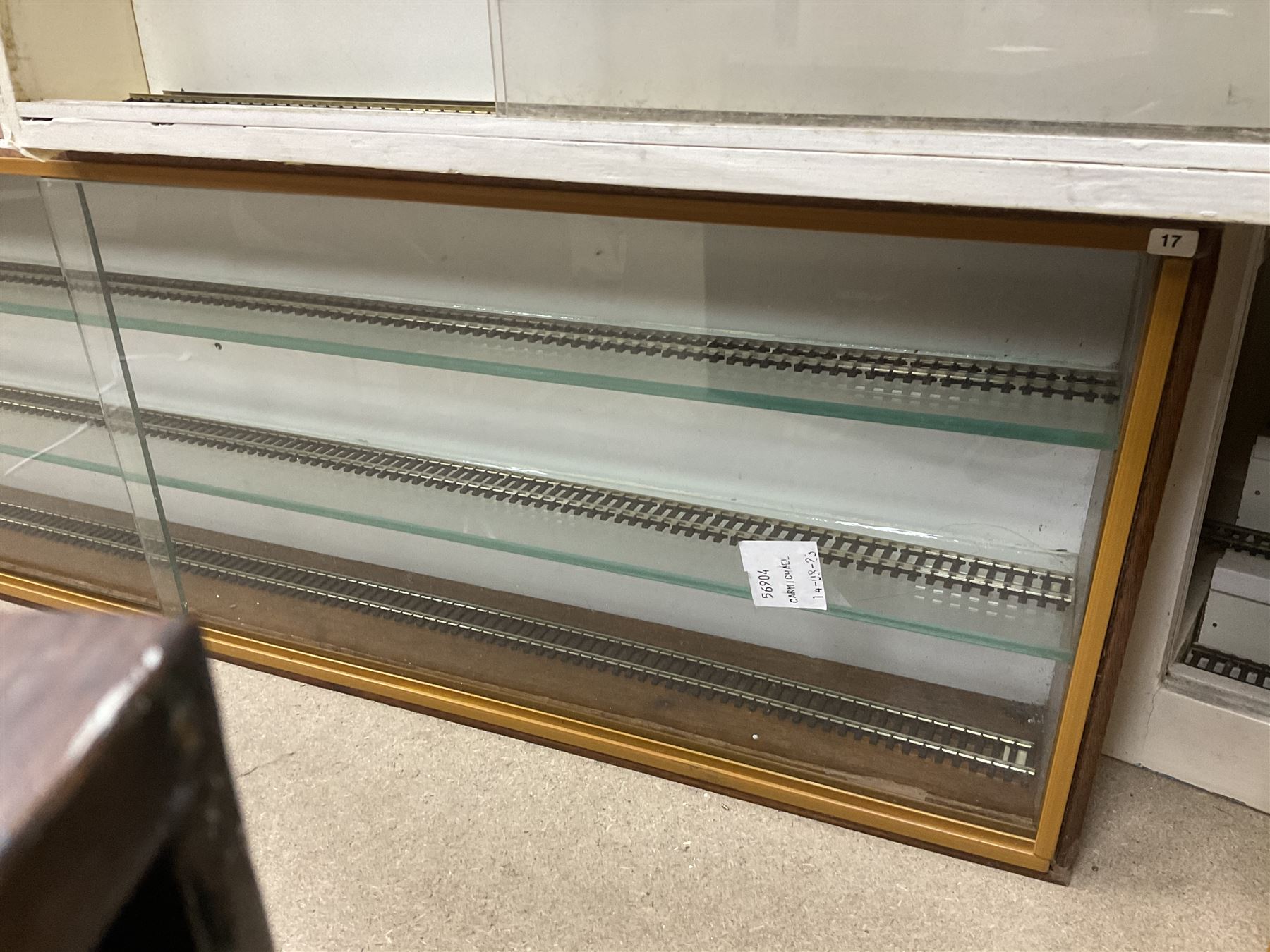 Six shelved cabinets for displaying ‘00’ gauge locomotives comprising plain plywood and white painted examples with track applied to various shelves, largest H63cm, W107cm, D27cm; Collection of tools for building model locomotives to include Weller PU-2D Soldering Pencil and Standard Tip Soldering Iron 20W/230V, Humbrol Modellers Airbrush, Power Supply Units and two wooden chests one of which housing a collection of tools including tweezers, scalping tools, wrenches etc 