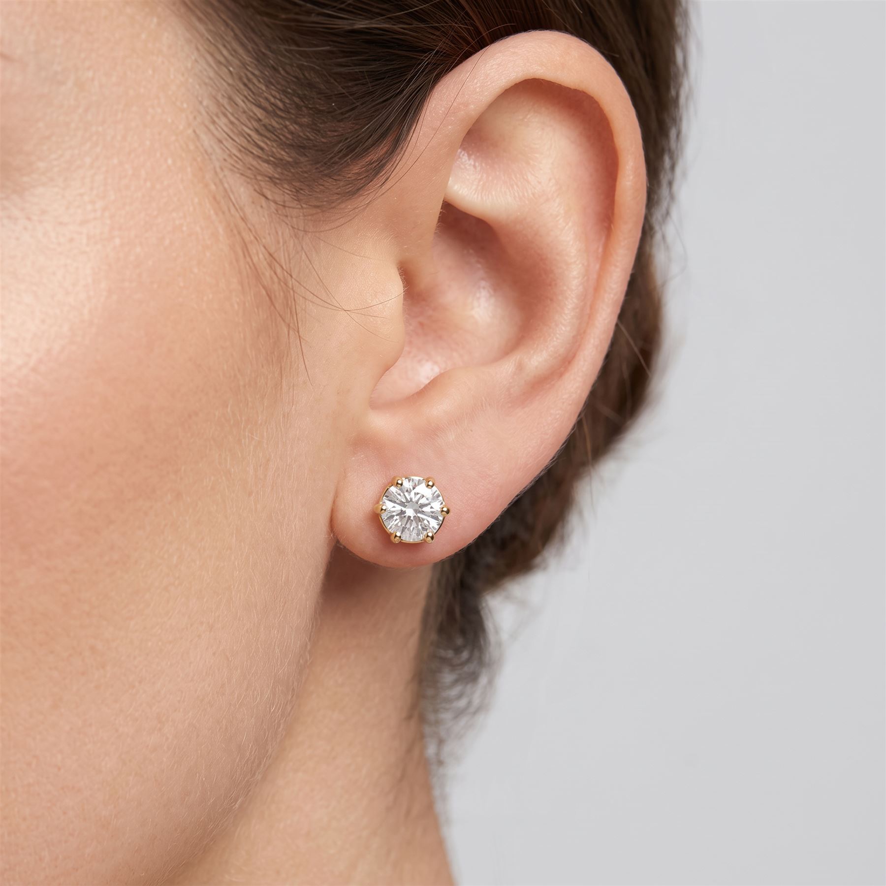 Pair of 18ct gold diamond earrings, each screw back stud set with a single round brilliant cut diamond, total diamond weight approx 3.15 carat