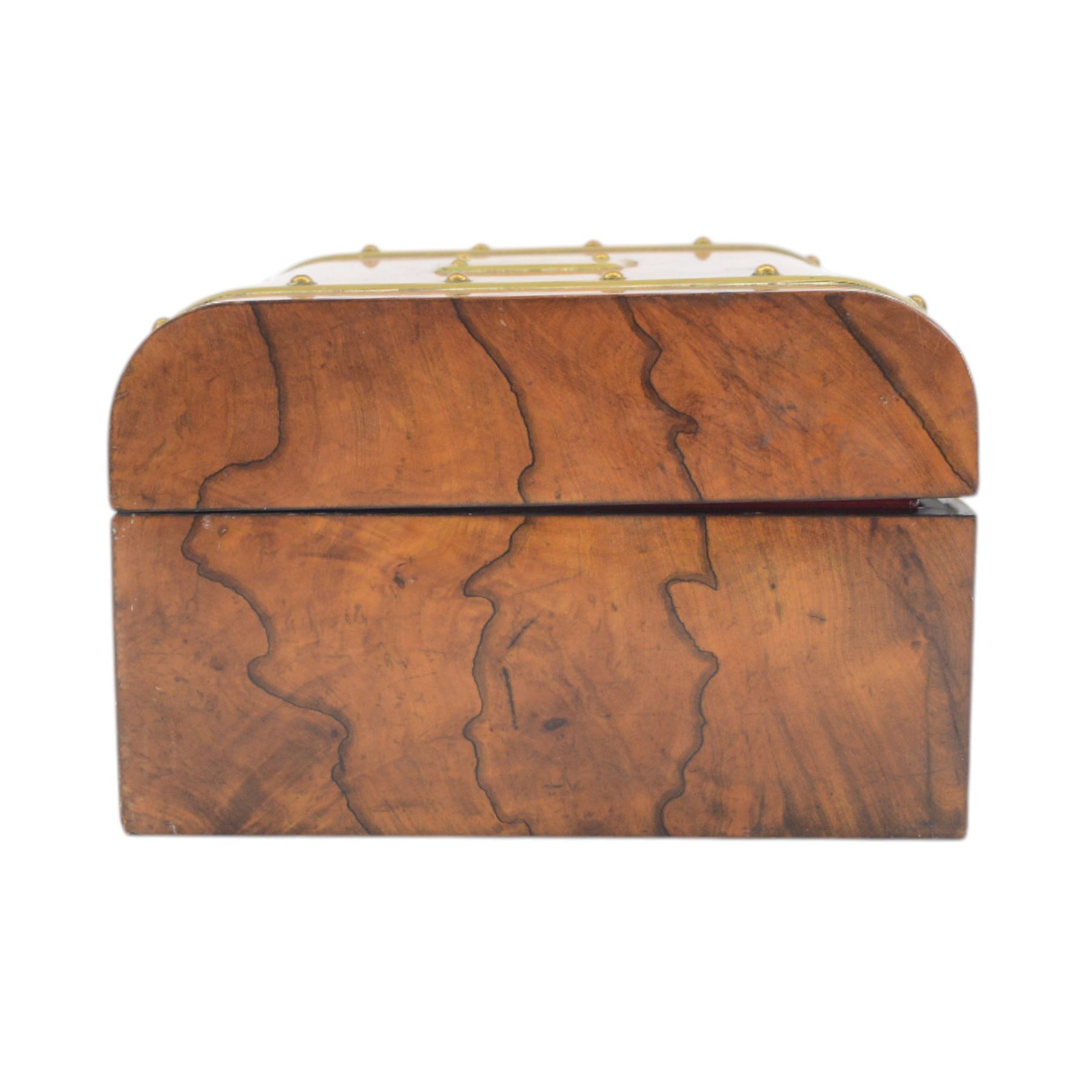 19th century walnut and brass bound games compendium box, painted to enhance the grain, of rectangular form, the hinged opening cover with rounded sides, central brass cartouche with engraved lion crest, and brass riveted straps, opening to reveal a red leather and blue silk lined compartmented interior, with fold-down games board, and lift-out tray containing playing cards, ebony turned dice towers, white and red stained bone draughts, and chess pieces, ivory dice, and ivory and ebony whist markers, and brass bezique board, cribbage board and markers, H15cm W32cm D24cm
This lot has been registered for sale under Section 10 of the APHA Ivory Act