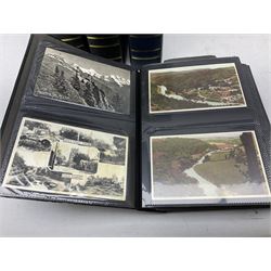 Four modern albums containing approximately eight-hundred and fifty Edwardian and later postcards including real photographic and printed topographical, novelty leather and wooden cards, applique etc