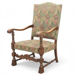 Early 20th-century Jacobean revival open oak armchair, arched padded back, and seat button upholstered  in foliate tapestry style fabric, with scroll carved arms on turned supports, raised on block supports united by turned shaped stretchers 