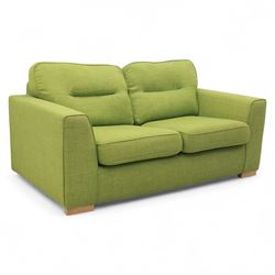 Contemporary lime green upholstered sofa bed, with rectangular arms and two seat cushions, the back with two stitched backrest cushions, on low block feet