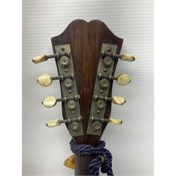 Late 19th/early 20th century Italian lute back mandolin with segmented back and spruce top; bears maker's label for Pietro Tonelli Napoli; together with a mandolin instruction booklet and a folding music stand L60.5cm