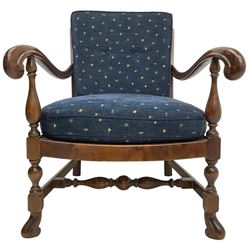 Early 20th century stained beech framed armchair, cane panel back over scrolled arm terminals, raised on turned supports united by turned H-stretcher, with patterned blue upholstered loose back and seat cushions