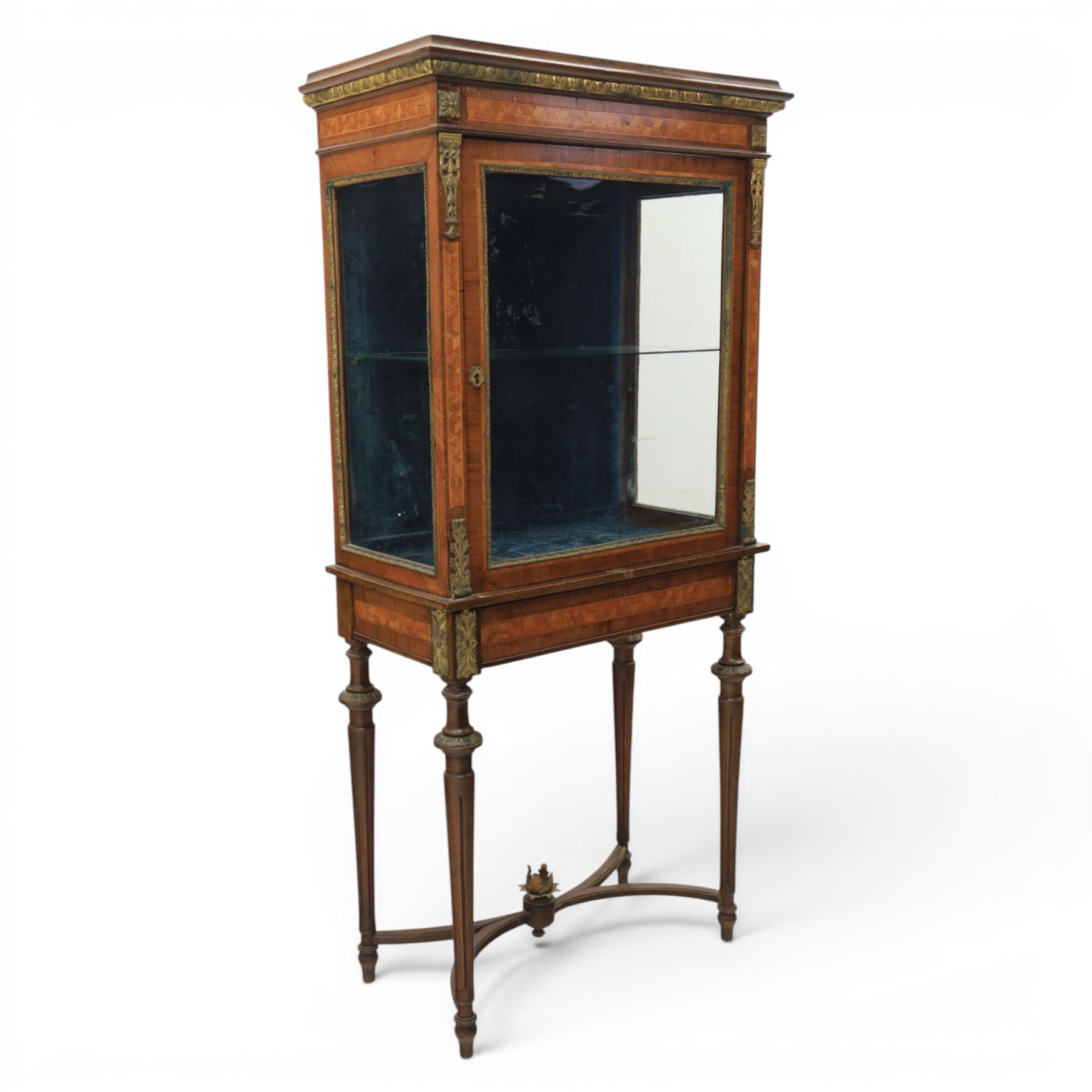 French kingwood display vitrine, rectangular glazed case with baized lined interior, parquetry banding and gilt metal bead mounts, applied gilt metal foliate corner mounts, raised on turned supports united by shaped undertier stretchers