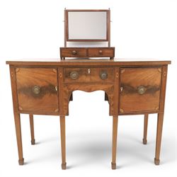 Regency design mahogany bow-front sideboard and dressing mirror, the sideboard with satinwood stringing, central frieze drawer over shaped apron flanked by cupboard doors with oval satinwood line inlaid decoration and circular pressed brass handles, on square tapering supports, the dressing mirror fitted with two drawers to the base (Mirror H 47cm, D 19cm, W 47cm)