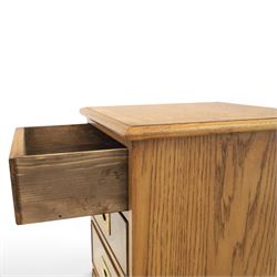 Pair of burr oak bedside tables with campaign brass handles, inlaid and crossbanded top, above four graduating drawers with cockbeaded edges, raised on a plinth base 