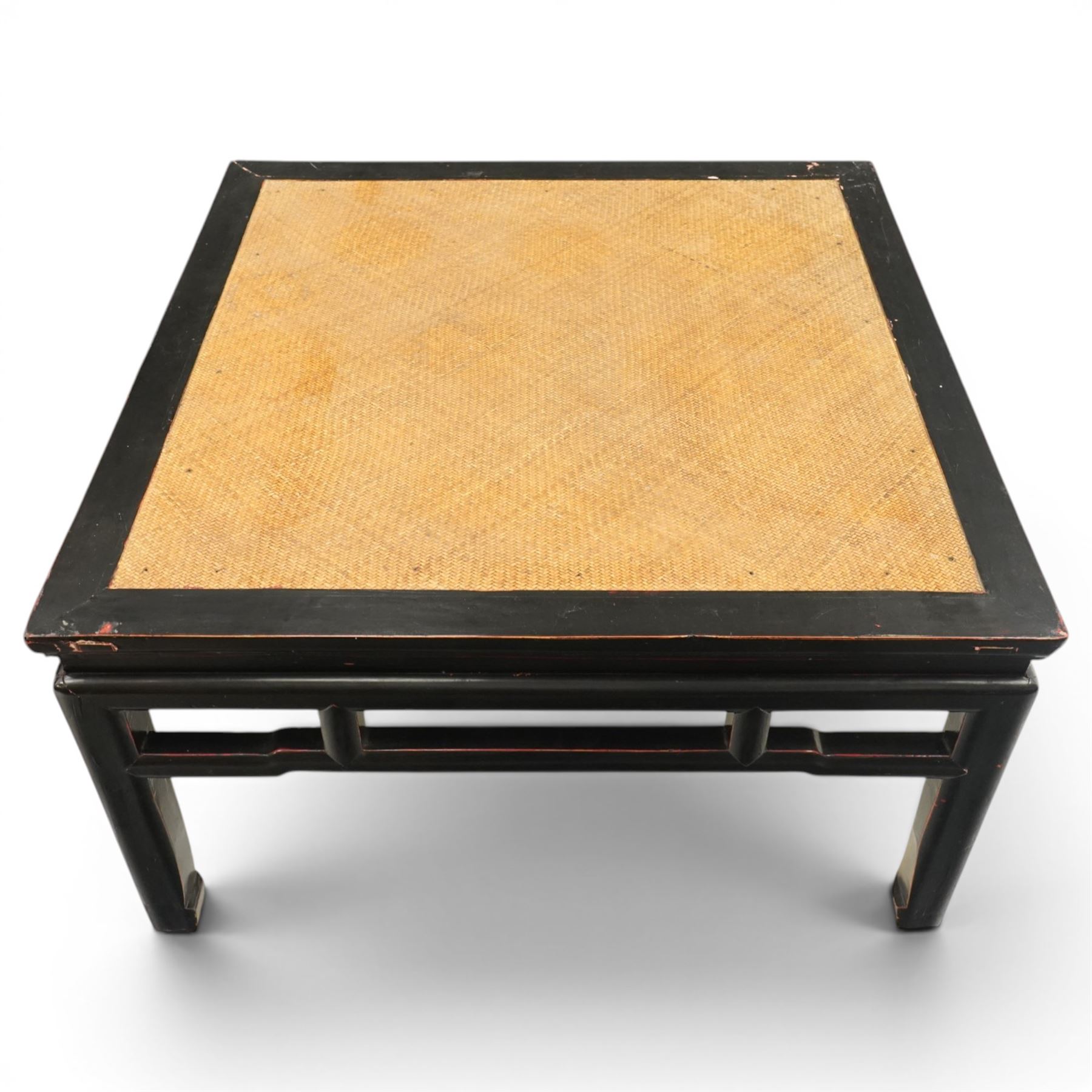 Pair of 20th century Chinese lacquered low coffee or lamp tables, square top with inset woven panel, over shaped frieze rails, raised on moulded square supports