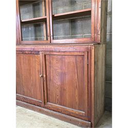 Large pitch pine library bookcase, early 20th century, the top fitted with six doors enclosing six shelves, above six panelled doors to base, for restoration. Splits in four for transportation.  H285cm, L426cm, D49cm - COLLECTION BY APPOINTMENT FROM: The White House, Thirsk Road, Easingwold, York, YO61 3NF - CALL 01723 507111 TO ARRANGE