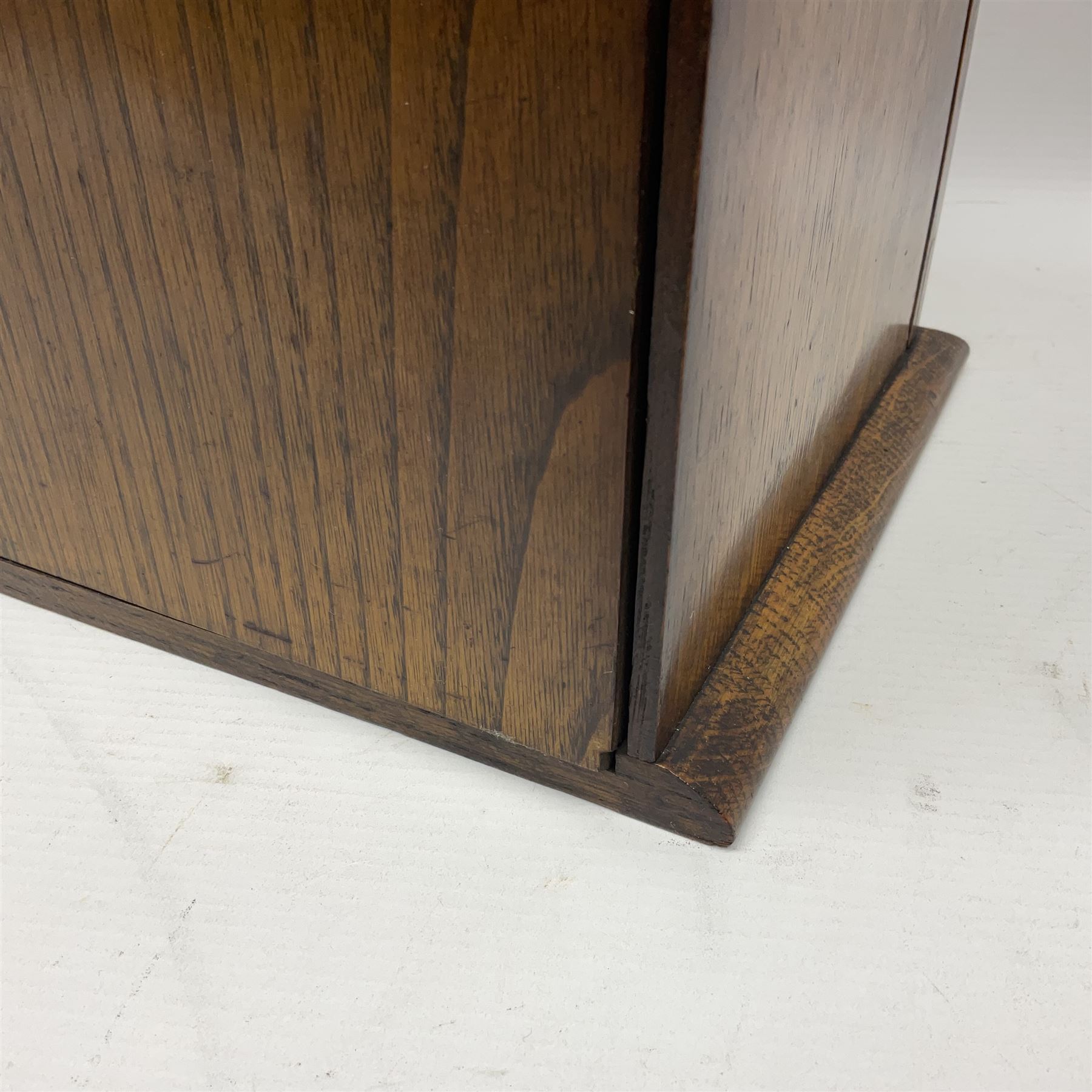 Edwardian oak smokers cabinet with the single glazed door to fitted interior having a single draw and pipe rack, H40cm