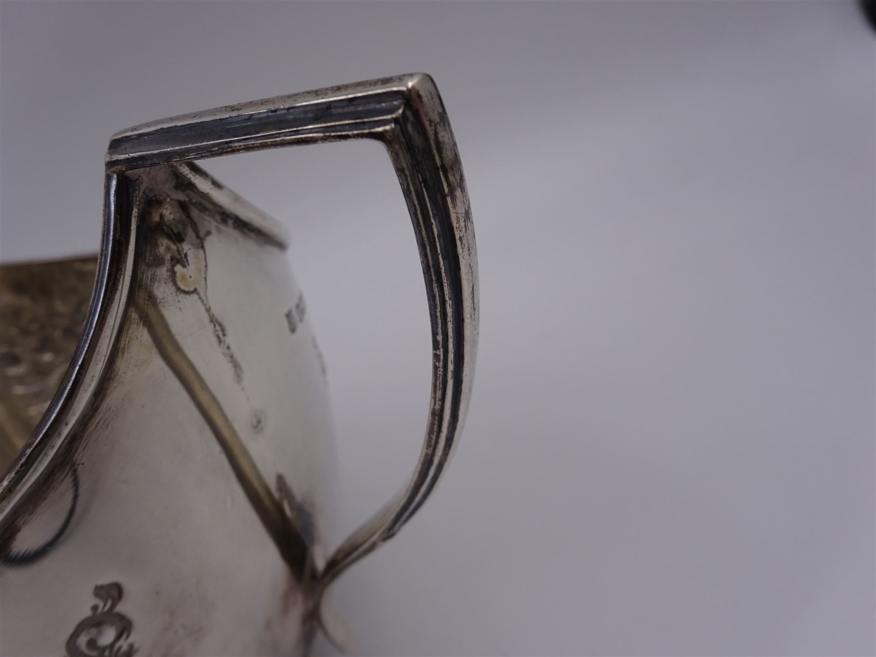 Late Victorian silver milk jug and twin handled open sucrier, each of oval form with angular handles and embossed floral, foliate and C scroll decoration, hallmarked James Deakin & Sons, Sheffield 1899, sucrier with handles H10.8cm