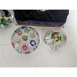 Strathearn paperweight, with blue floral decoration, boxed, together with four domed glass paperweights, including millefiori examples
