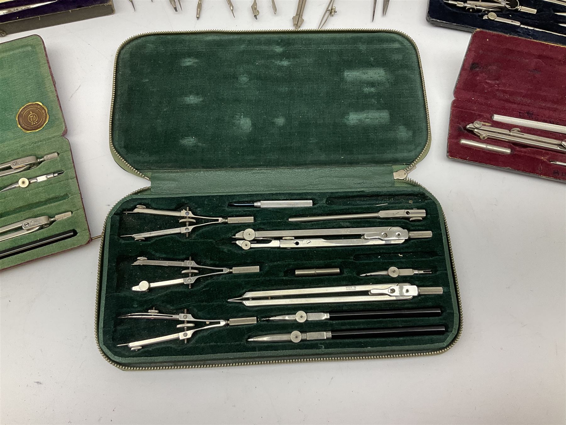 Negretti & Zambra drawing instrument set, the ruler with manuscript name 'F/Sgt. F. Hamilton R.A.F. 194(?)', cased; four other drawing instrument sets by Anker-Precision Germany, EcoBra, Temple etc, all cased; and quantity of loose drawing instruments