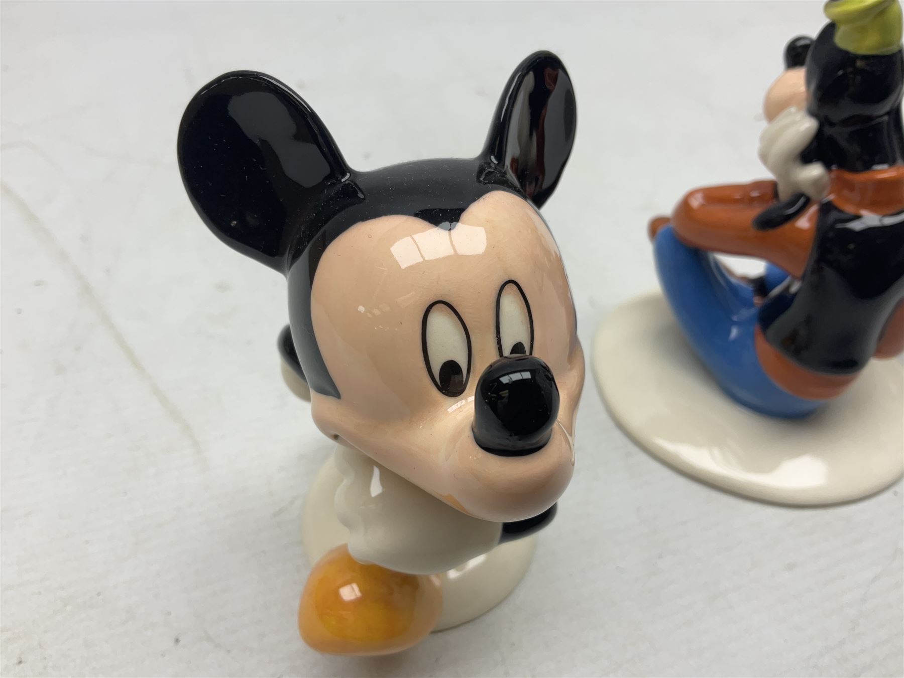 Three Royal Doulton The Mickey Mouse Collection figurines comprising Mickey Mouse MM1, Minnie Mouse MM2, and Goofy MM5, together withe three Royal Doulton limited edition miniature snowman character jugs comprising Christmas Stocking Snowman D7124, Christmas Cracker Snowman D7158 and Snowman D7062, all with original boxes 