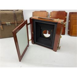 Thornton Pickard folding plate camera in mahogany and lacquered brass, no.529946 and no.529947, field model with canvas wrapped box, three mahogany photographic plates, 'Busch's Portrait Aplanat No4 Foc.14inc' lens and a wooden tripod
