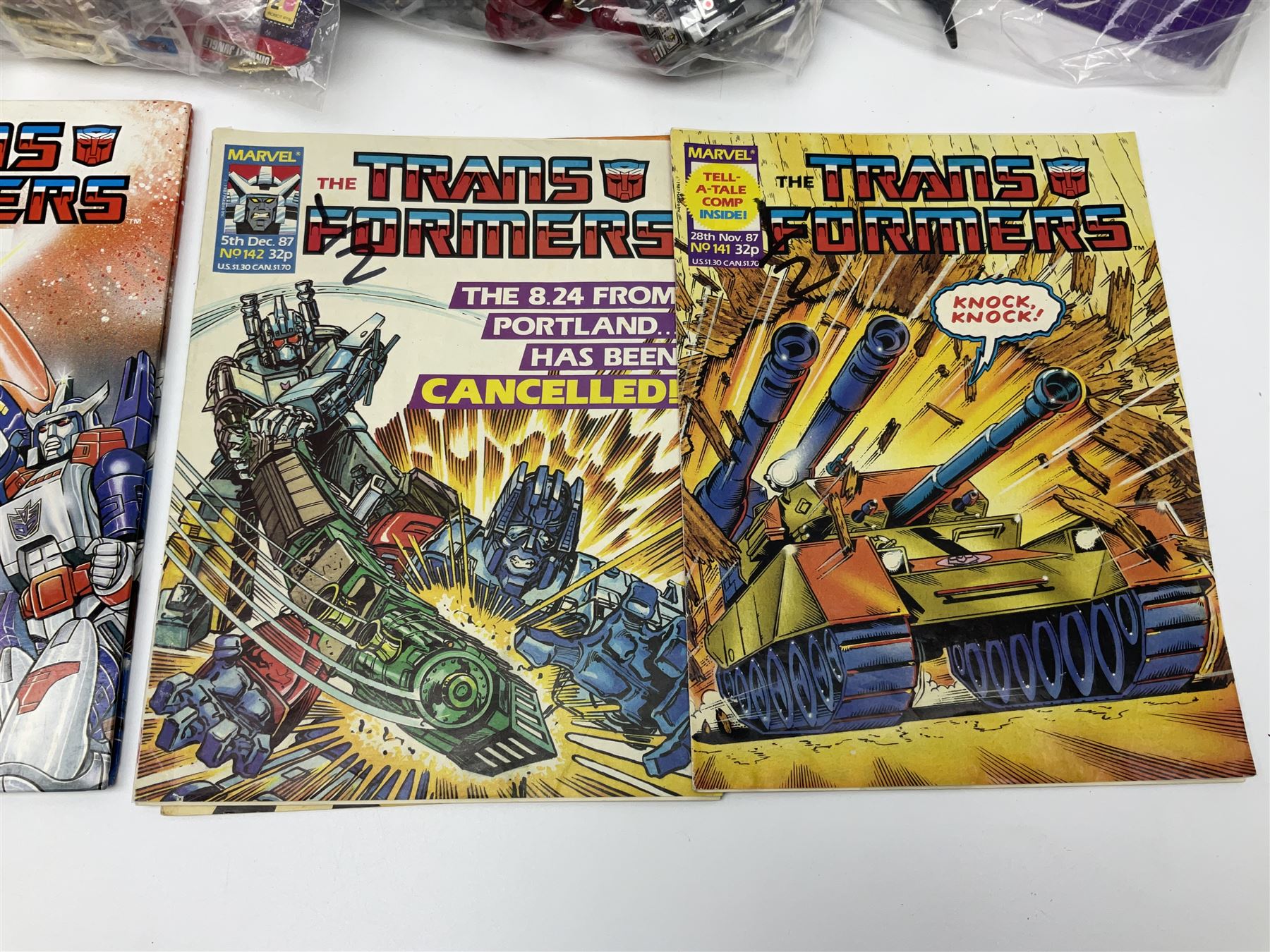 Four 1980sTransformer G1 - Optimus Prime 1984; DinoBot Sludge (Diplodocus) 1984; Cyclonus 1986; and Runamuck 1986; with paperwork; seven Bandai Robo Machines Robots/Transformers; almost fully stocked Panini Sticker album; two annuals; three comics; two posters; and Ladybird story book