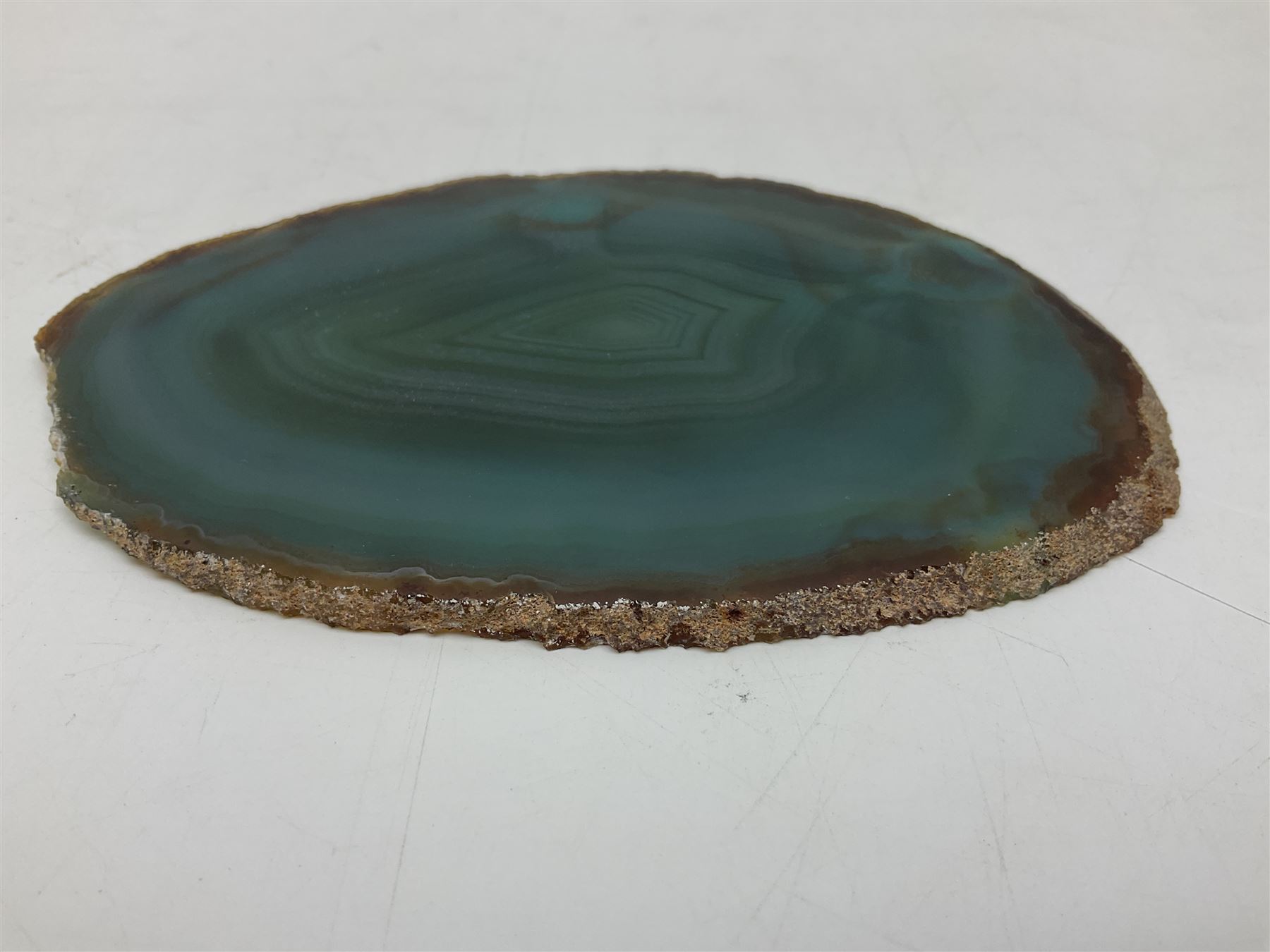 Pair of green agate slices, polished with rough edges raised upon silvered metal stands, H19cm