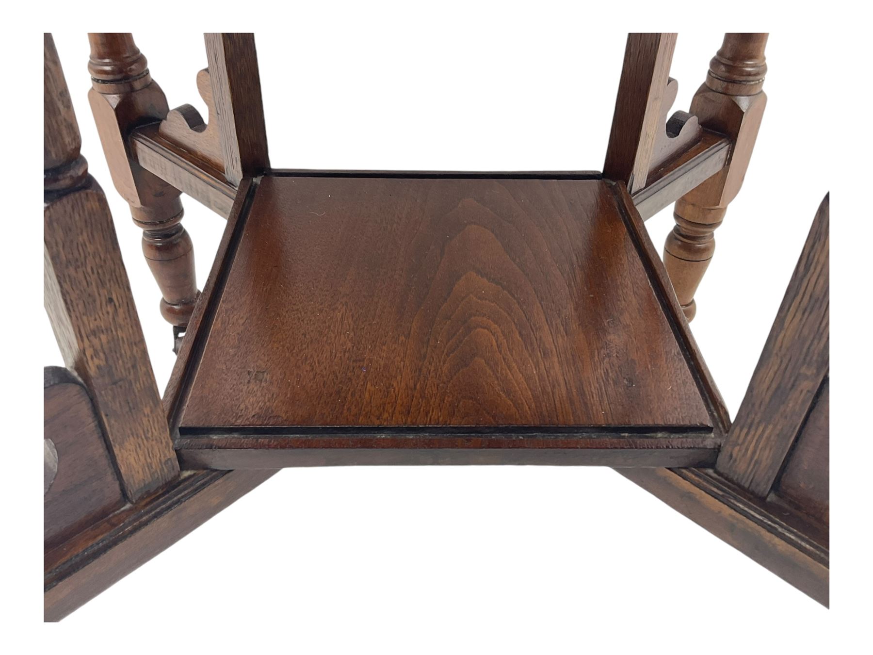 Victorian oak occasional table, octagonal top with bevelled edges, lower section fitted with a square undertier united by decorative shaped stretchers, on turned supports with castors